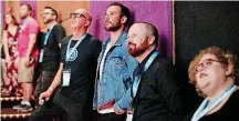  ?? [PHOTOS BY DOUG HOKE,THE OKLAHOMAN] ?? One of the 2018 deadCenter Film Festival’s Oklahoma Film Icon winners, Ryan Merriman, center, watches a highlight reel June 8 before the screening of “The Jurassic Games” at Harkins in Bricktown. With him are, left, deadCenter Executive Director Lance...