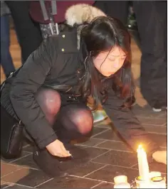  ??  ?? The scene at Market Square during the Candleligh­t Vigil in Memory of Yosuke Sasaki.