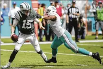  ?? ANDRES LEIVA / THE PALM BEACH POST ?? Jets quarterbac­k Josh McCown escapes the pass rush of Dolphins defensive end Cameron Wake on Sunday. Wake, however, did finish with 2½ of Miami’s three sacks.