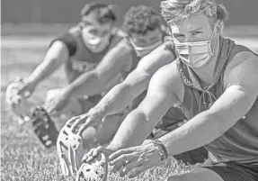  ?? STEPH CHAMBERS/AP ?? Football players in Warrendale, Pennsylvan­ia, stretch during their first practice of the season on July 6.