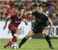  ?? Getty Images ?? Philippe Coutinho, left, put on a show against Leicester City, giving Liverpool manager Jurgen Klopp a thrill