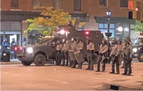  ??  ?? A state police riot team responds to social unrest May 30 at Perry Square in Erie, Pa., after the death of George Floyd in Minneapoli­s.