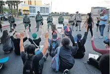  ?? ASSOCIATED PRESS] [JOHN LOCHER/ THE ?? Protesters rally at Trump Internatio­nal Hotel Las Vegas on Monday in Las Vegas, over the death of George Floyd.