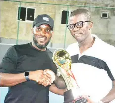  ??  ?? Former Super Eagles skipper, Austin Okocha ( left), presenting the winner’s trophy to Emelie Okika, who won the men’s singles of the Luik Tennis and Recreation Club Members League… at the weekend