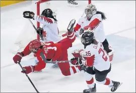  ?? JULIO CORTEZ — THE ASSOCIATED PRESS ?? Like she did on this hit by Russia’s Lyudmila Belyakova (10) in a semifinal game Monday, Brigette Lacquette, second from left, has had to endure a lot while playing hockey.