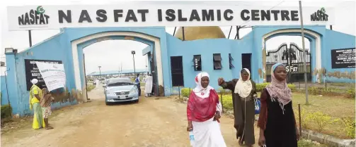  ??  ?? ASEESE: Faithful walk past the main gate after the Sunday worship at the Nasrul-lahi-li Fathi Society of Nigeria (NASFAT), in Aseese, Ogun State. Sunday morning is usually the preserve of Christian pastors in the Nigerian megacity of Lagos but a new...