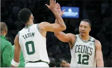  ?? STEVEN SENNE — THE ASSOCIATED PRESS ?? Boston Celtics’ Jayson Tatum, left, celebrates with teammate Grant Williams during Boston’s Game 7, Eastern Conference semifinals win over the Milwaukee Bucks Sunday. Williams led the way with 27 points.