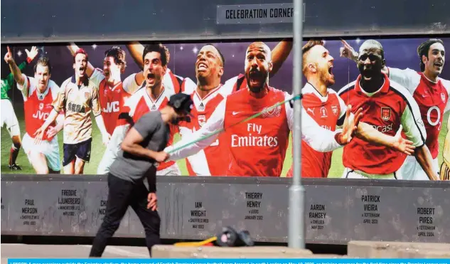  ?? –— AFP ?? LONDON: A man exercises outside the Emirates stadium, the home ground of English Premier League football team Arsenal, in north London on May 19, 2020, as training resumes for the first time since the Premier League was halted due to the COVID-19 pandemic.