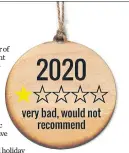  ?? THE NEW YORK TIMES ?? An ornament sold by the Fig Tree in Chicago rates the year. Holiday decor vendors are leaning into the grief, anxiety and nihilism of this year, and customers are buying it up.