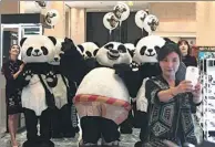  ?? AHN YOUNG-JOON/ ASSOCIATED PRESS ?? A woman takes a selfie with workers wearing panda costumes during a promotiona­l event for Chinese tourists at a department store in Seoul, South Korea, in April.