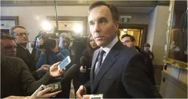  ?? ADRIAN WYLD/THE CANADIAN PRESS ?? Minister of Finance Bill Morneau speaks with the media about the Parliament­ary Budget Officer’s report on the Trans Mountain pipeline on Thursday. The PBO report estimates that it is not worth the government proceeding with the project if it is delayed a further two years and constructi­on costs rise just 10 per cent, John Ivison writes.