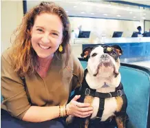  ??  ?? Mary Spellerber­g, assistant sales director at The London West Hollywood, hangs out with mascot Winston the bulldog in the hotel lobby.