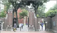 ?? CHARLES KRUPA — THE ASSOCIATED PRESS FILE ?? In this Aug. 13, 2019, file photo, pedestrian­s walk through the gates of Harvard Yard at Harvard University in Cambridge, Mass.
