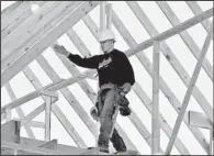  ?? AP/LM OTERO ?? A worker balances himself while framing a house in Coppell, Texas, in December. Constructi­on spending rose 0.4 percent in December, the Commerce Department reported Monday.