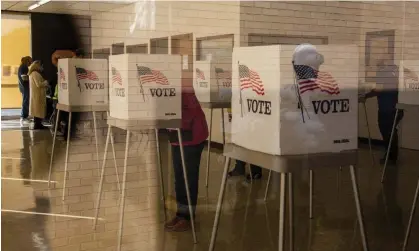  ?? ?? People cast ballots at an early voting polling location for the 2020 presidenti­al elections in Adel, Iowa. Photograph: Bloomberg/Getty Images