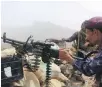  ??  ?? A pro-government loyalist fires on Houthi rebels