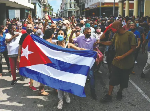  ?? YAMIL LAGE / AFP VIA GETTY IMAGES FILES ?? People march in a recent Havana demonstrat­ion to back the government of Cuban President Miguel Diaz-canel.