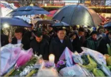  ?? GALIT RODAN — THE CANADIAN PRESS VIA AP ?? People bow their heads in silence at a vigil on Yonge Street in Toronto, Tuesday after multiple people were killed and others injured in Monday’s deadly attack in which a van struck pedestrian­s on a Toronto sidewalk.