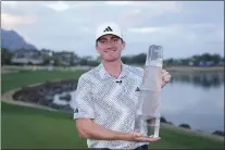  ?? RYAN SUN — THE ASSOCIATED PRESS ?? Nick Dunlap holds the trophy after winning the American Express golf tournament, Sunday, Jan. 21, 2024, in La Quinta, Calif.