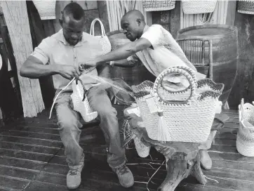  ?? PHOTOS BY PAUL H WILLIAMS ?? From artisan to artist, Omar Daley (right) showing Lennox Coke how it is done.