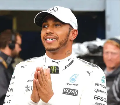  ??  ?? Mercedes driver Lewis Hamilton of Britain celebrates at the end of the qualifying session for today’s Italian Formula One Grand Prix Photo: AP