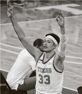  ?? Chuck Burton / Associated Press ?? UT’s Kamaka Hepa celebrates after a teammate’s 3-pointer against Kansas State on Saturday in Austin. Hepa himself hit 5 of 8 3-pointers in the win.