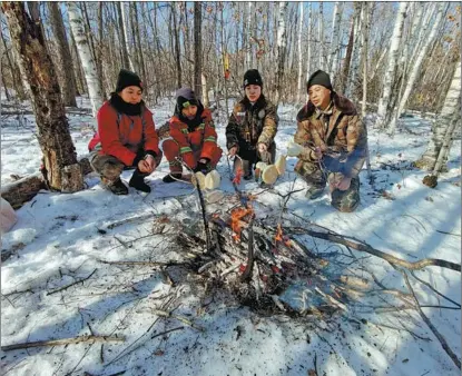  ?? PROVIDED TO CHINA DAILY ?? Xu Chunmei (second right) patrols forests with her team in Heilongjia­ng province.