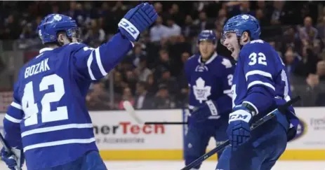  ?? STEVE RUSSELL/TORONTO STAR ?? Leafs left wing Josh Leivo skates to congratula­te teammate Tyler Bozak on Thursday. In his first game back from a concussion, Bozak scored twice.