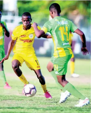  ??  ?? Clive Beckford of Charlie Smith (left) goes on the attack against Vindiesel Isaacs of Kingston High school in their ISSA/Digicel Manning Cup fixture played at Breezy Castle on September 14.