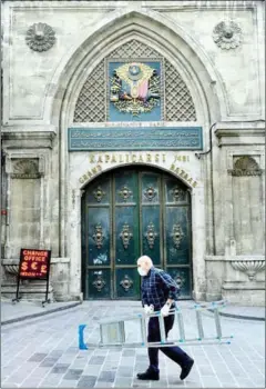  ?? AFP ?? A man walks in front of the iconic Grand Bazaar’s closed main gate.