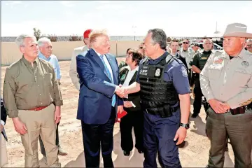  ??  ?? Trump greets Customs and Border Protection director of Field Operations Pete Flores as he stands with House Minority Leader Kevin McCarthy (left) and other officials during a visit to the US-Mexico border wall in Calexico. — Reuters photo