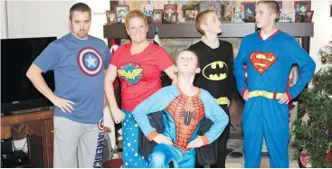  ??  ?? Even as her oldest son turns 20, Amy Wilson says her boys like dressing up in matching pyjamas for the holidays.