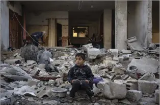  ?? FATIMA SHBAIR - THE ASSOCIATED PRESS ?? A Palestinia­n boy sits on the rubble of a destroyed building after an Israeli strike in Rafah, southern Gaza Strip, on Friday.