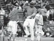  ?? Michael Dwyer Associated Press ?? RAFAEL DEVERS greets Red Sox teammate Christian Vazquez (7) after Devers hit a solo home run.