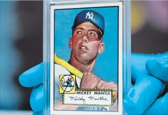  ?? ASSOCIATED PRESS FILE PHOTO ?? The five Mickey Mantle cards found by a New Jersey man and his brother are indeed the “Holy Grail” of baseball cards — the 1952 Topps Mickey Mantle. However, the cards discovered aren’t in as good of condition as this one from the Colorado History...