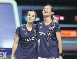  ??  ?? SURPRISE PACKAGE: Thailand’s Jongkolpha­n Kititharak­ul, right, and Rawinda Prajongjai celebrate after their triumph in the women’s doubles semi-finals.
