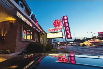  ??  ?? The neon at Gorat’s - known as billionair­e Warren Buffett’s favourite steakhouse - hasn’t changed in 70-plus years.