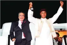  ??  ?? In this Thursday, Aug 20, 2009 file photo, Libyan Abdel Baset Al-Megrahi, who was found guilty of the 1988 Lockerbie bombing, left, and son of the Libyan leader Seif Al-Islam Gadhafi, right, gesture on his arrival at an airport in Tripoli, Libya.