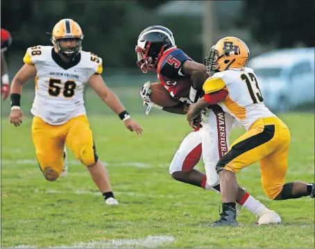  ?? [EMMA HOWELLS/DISPATCH] ?? Franklin Heights defender Dequintis Sutton (13) hauls down Eastmoor Academy wide receiver Napoleon Harris after a catch. DeSales 50, Royal Imperial College 0: