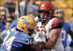  ??  ?? FILE—In this Oct. 6, 2018, file photo, Syracuse offensive lineman Koda Martin, right, blocks Pittsburgh defensive lineman Amir Watts (34) during an NCAA football game in Pittsburgh.