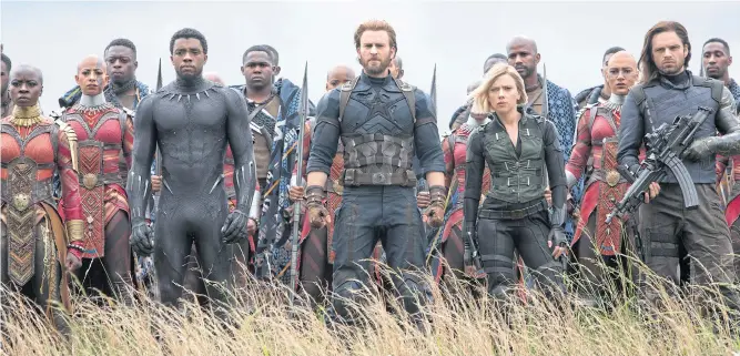  ??  ?? BEARD IN DEN: Above right, Chris Evans returns to his signature role in ‘Avengers: Infinity War’. SAVIOURS: Below, earth’s greatest heroes rally to save the planet in the new ‘Avengers: Infinity War’, among them (from left) Okoye (Danai Gurira), the...