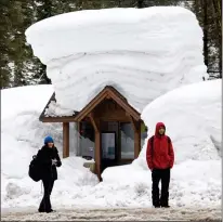  ?? ?? A snow-topped bus stop in Alpine Meadows on Saturday provides a glimpse of the Lake Tahoe region’s immense snowpack this winter. Hundreds of inches of snow have fallen on the mountainou­s region.