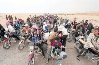  ?? PHOTO: REUTERS ?? Getting away . . . People fleeing from areas surroundin­g Euphrates River dam, east of Raqqa city, ride their motorcycle­s towards Syrian Democratic Forces (SDF)controlled areas, in Syria yesterday. The number of people fleeing Syria’s civil war into...