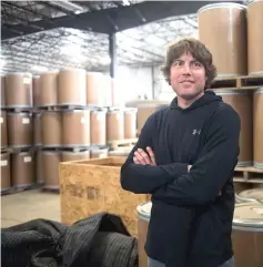  ??  ?? Farm manager Sandquist stands in front of roughly 80,000 pounds worth of ginseng that is ready to be shipped to China, at Hsu Ginseng Farm in Wausau.