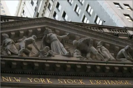  ?? MARY ALTAFFER — THE ASSOCIATED PRESS FILE ?? FILE- This file photo shows the New York Stock Exchange at sunset in lower Manhattan. The U.S. stock market opens at 9:30 a.m. EDT on Friday.