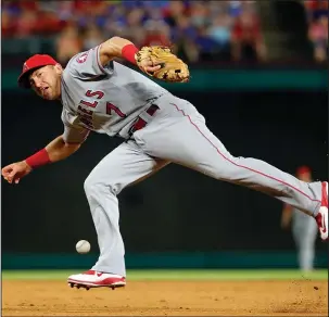  ?? The Associated Press ?? FLAG DAY RESCHEDULE­D: Angels second baseman Cliff Pennington (7) is unable to hold his grip on a Carlos Beltran single in the eighth inning Wednesday night in Arlington, Texas. A 5-4 Los Angeles victory prevented the host Rangers from clinching the AL...