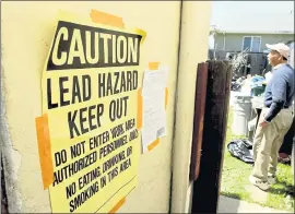  ?? KRISTOPHER SKINNER — STAFF ARCHIVES ?? Signs warn of the dangers as workers perform lead abatement work on a house in Richmond in 2012.