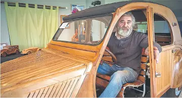  ??  ?? French cabinetmak­er Michel Robillard poses in his hand-built wooden 2CV Citroen car. — AFP photo