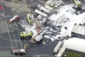  ?? AP/WFXT Boston 25 News ?? Emergency crews arrive Wednesday at the crash site of a World War II-era B-17 bomber at an airport in Windsor Locks, Conn.