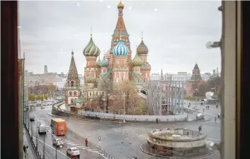  ?? — AFP ?? People walk through Red Square with Saint Basil’s Cathedral on the background in Moscow on Thursday.